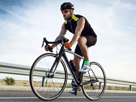 Road cyclist wearing a cycling helmet